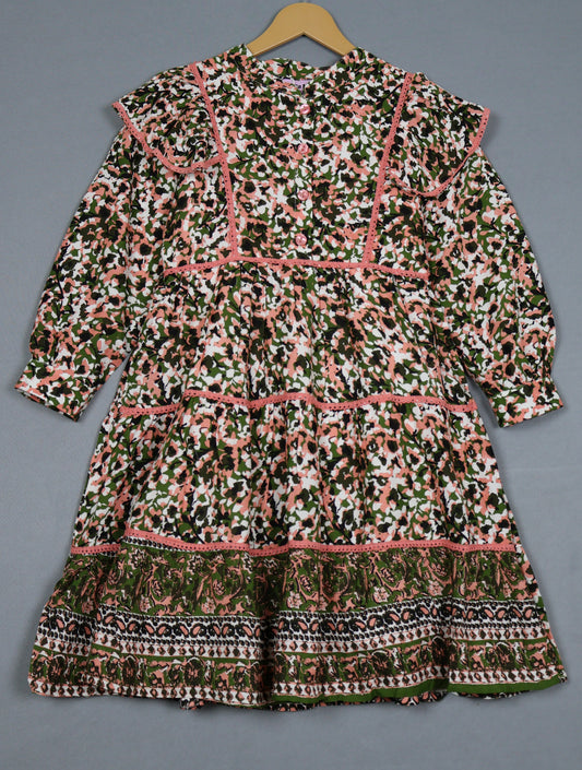 Patterned dress on a hanger against a gray background