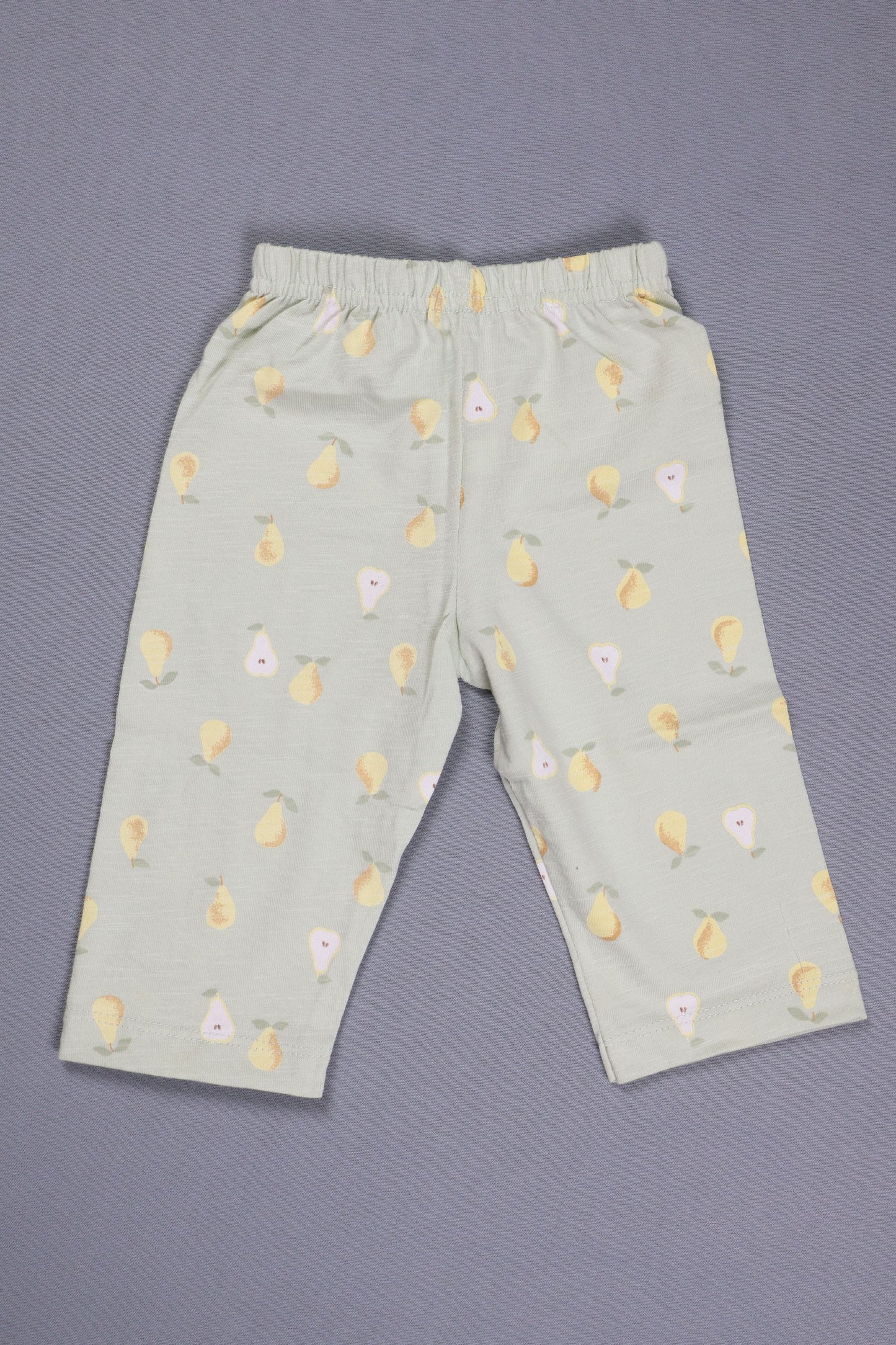 Light green pants with floral pattern on a gray background