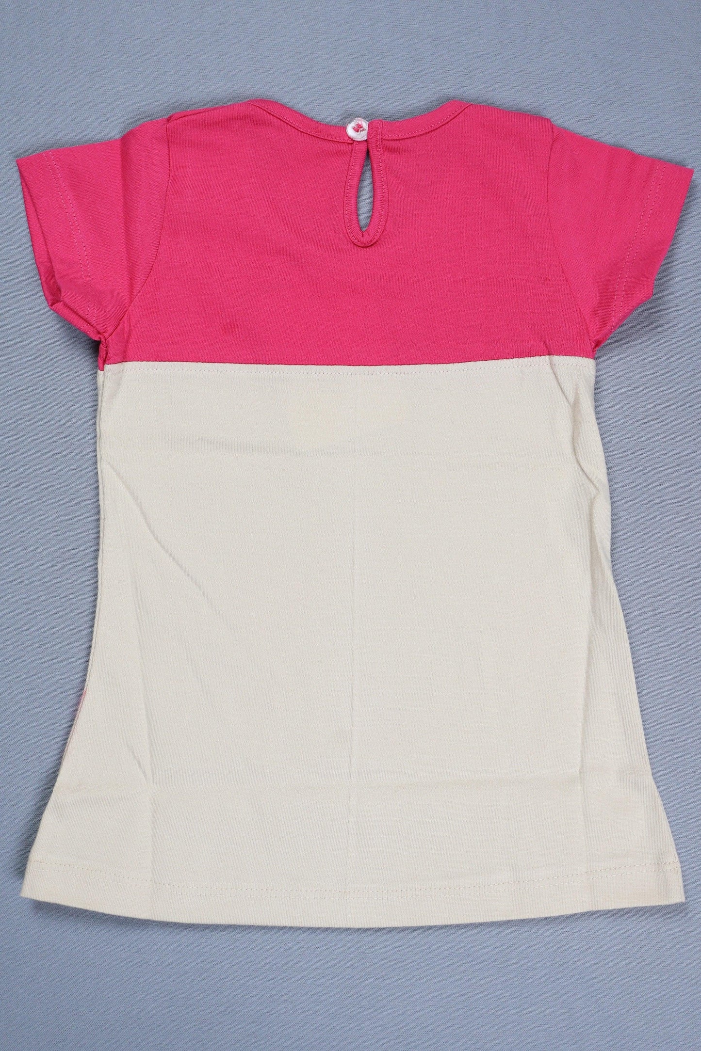 Back view of infants' cotton color-block frock with pink top and cream lower section