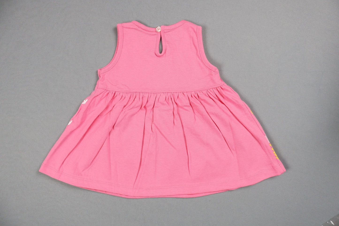 Pink swimsuit top on a gray background