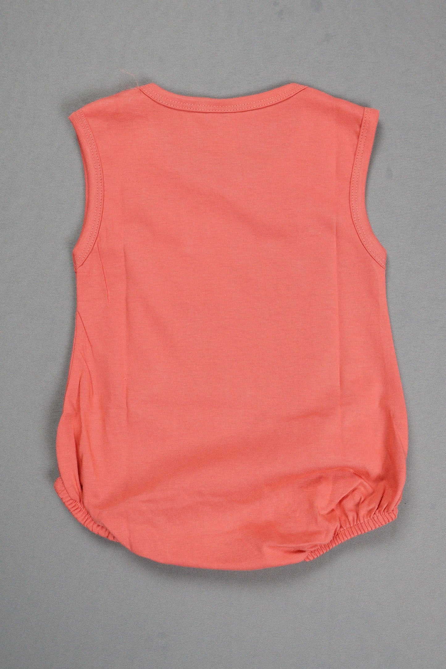 Pink sleeveless top on a gray background
