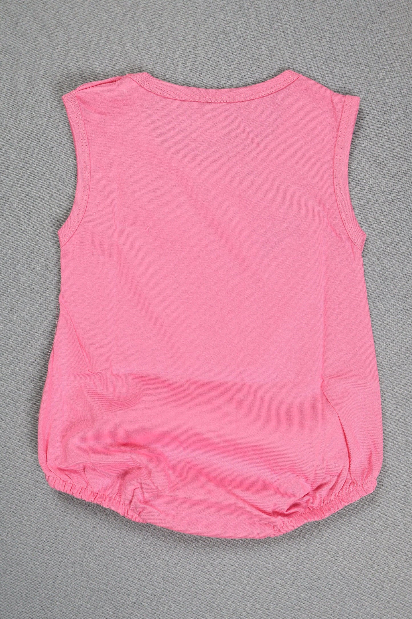 Pink sleeveless romper on a gray background