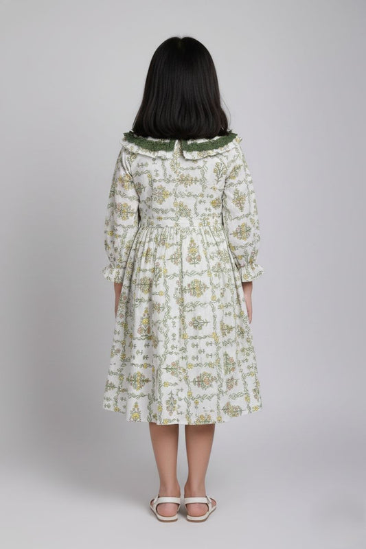 Woman wearing a floral dress with long sleeves on a plain background