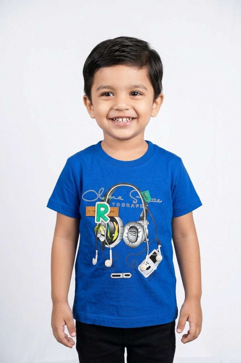 A kid wearing a FYST brand electric blue short-sleeved t-shirt featuring a large graphic of headphones with a green "R" patch and decorative white drawstring elements.