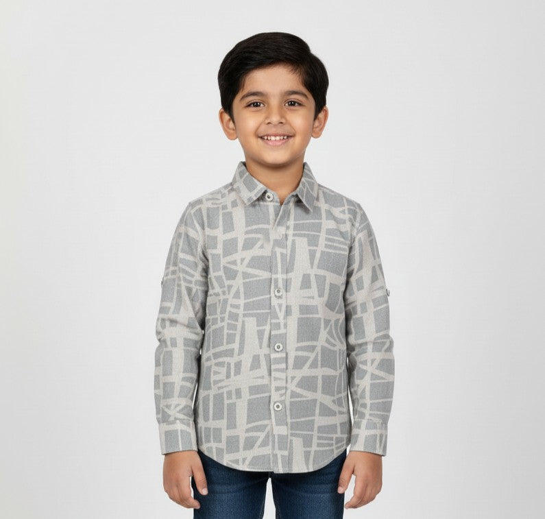 Young boy wearing a grey geometric print button-down shirt