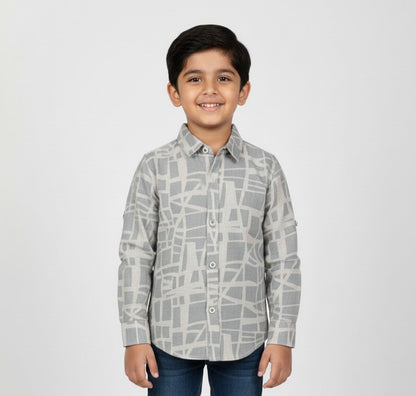 Young boy wearing a grey geometric print button-down shirt