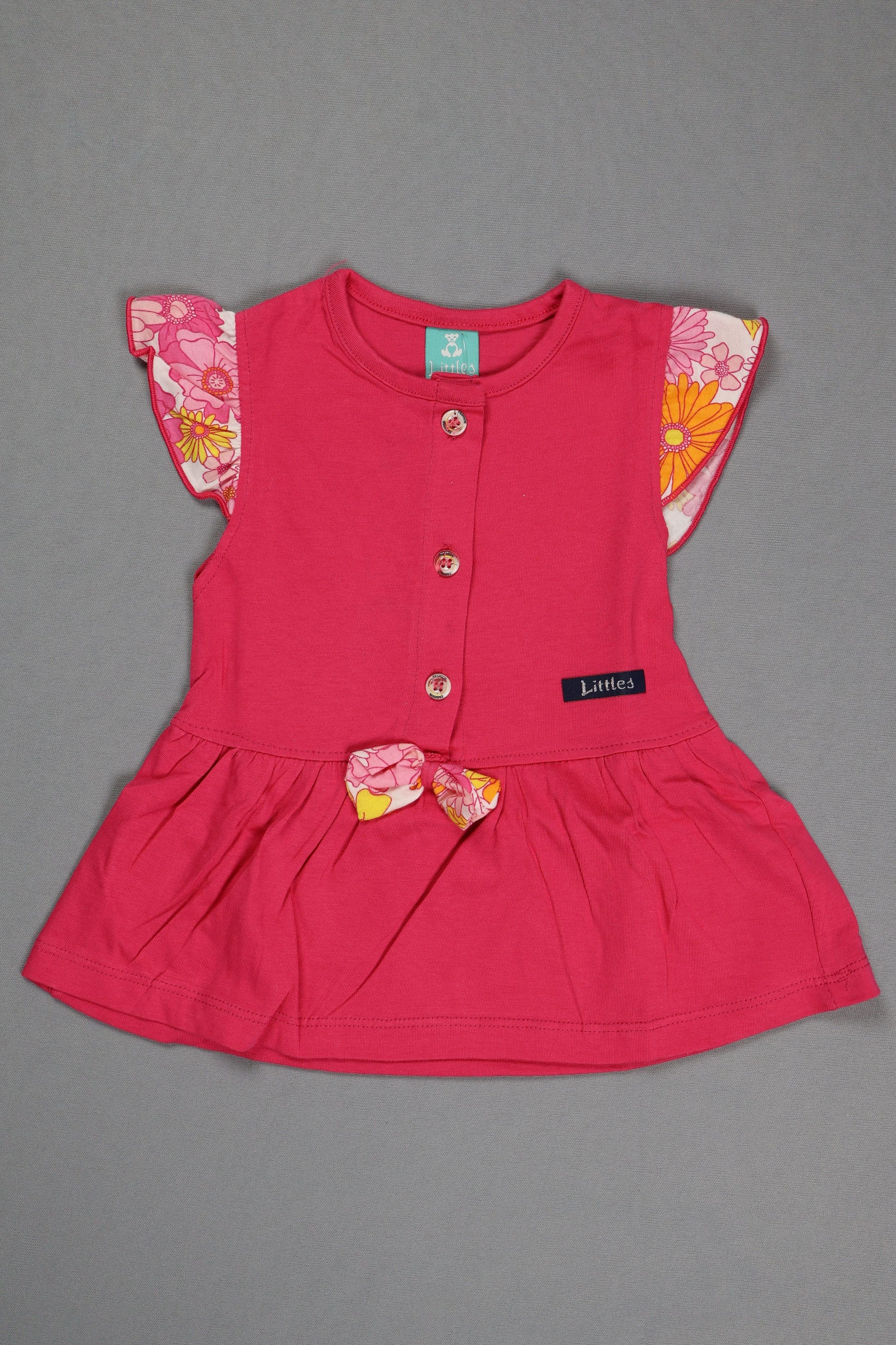 Pink dress with floral details on a gray background