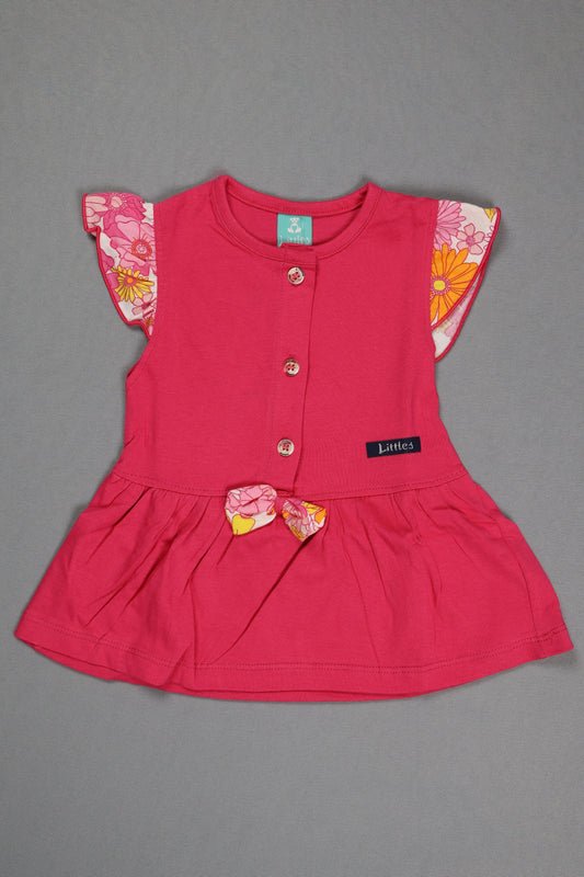 Pink dress with floral details on a gray background