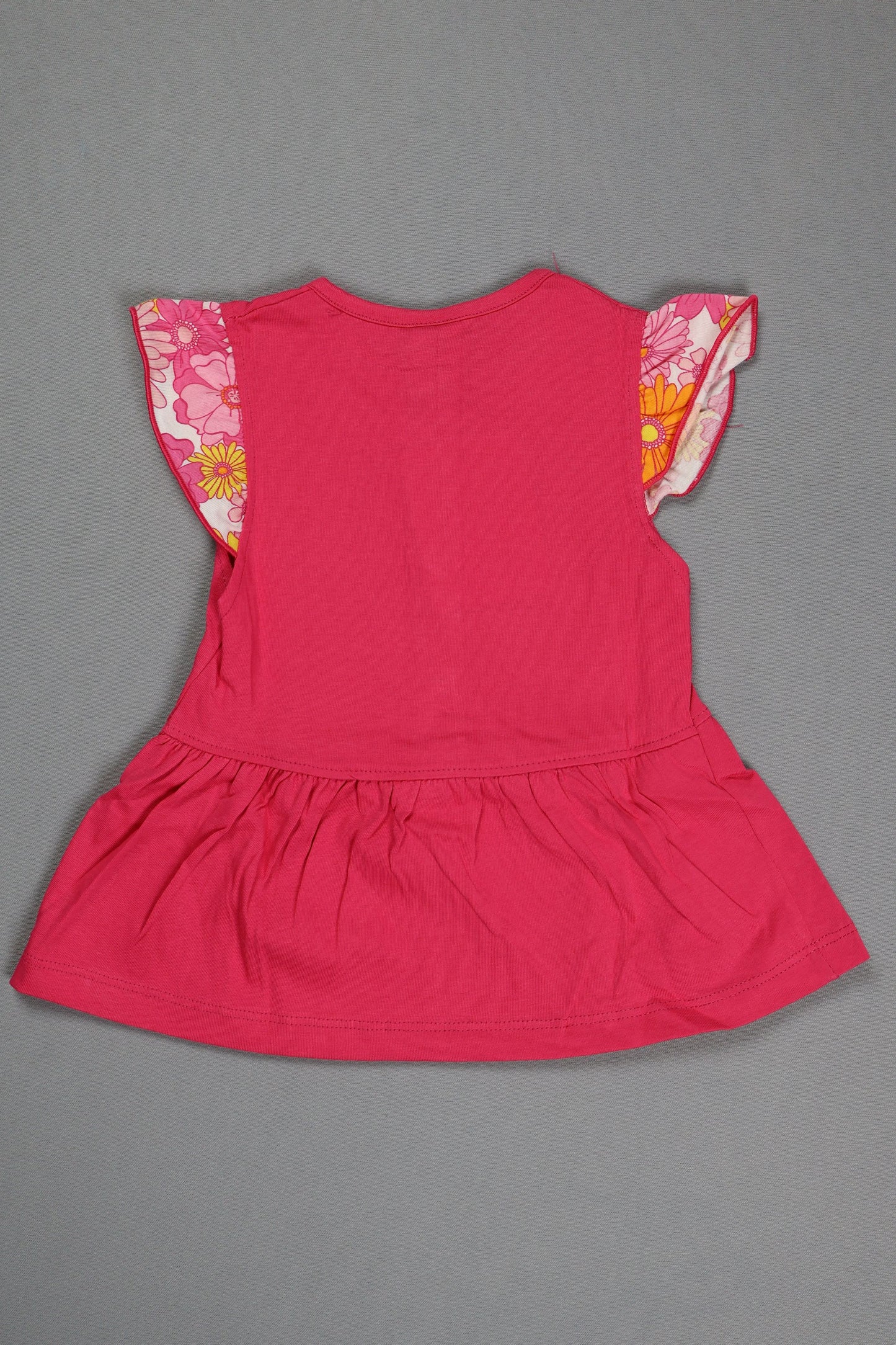 Red dress with floral lining on a gray background