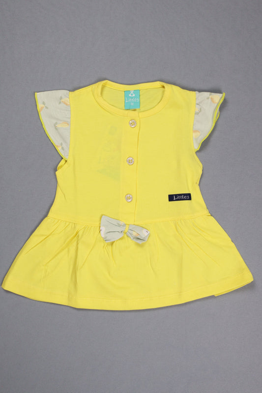 Yellow baby dress with floral lining on a gray background
