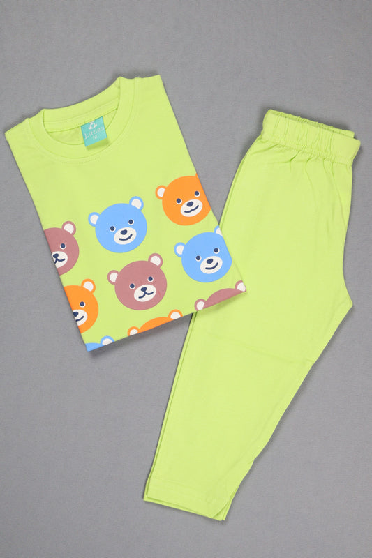 Green children's outfit with bear pattern on a gray background