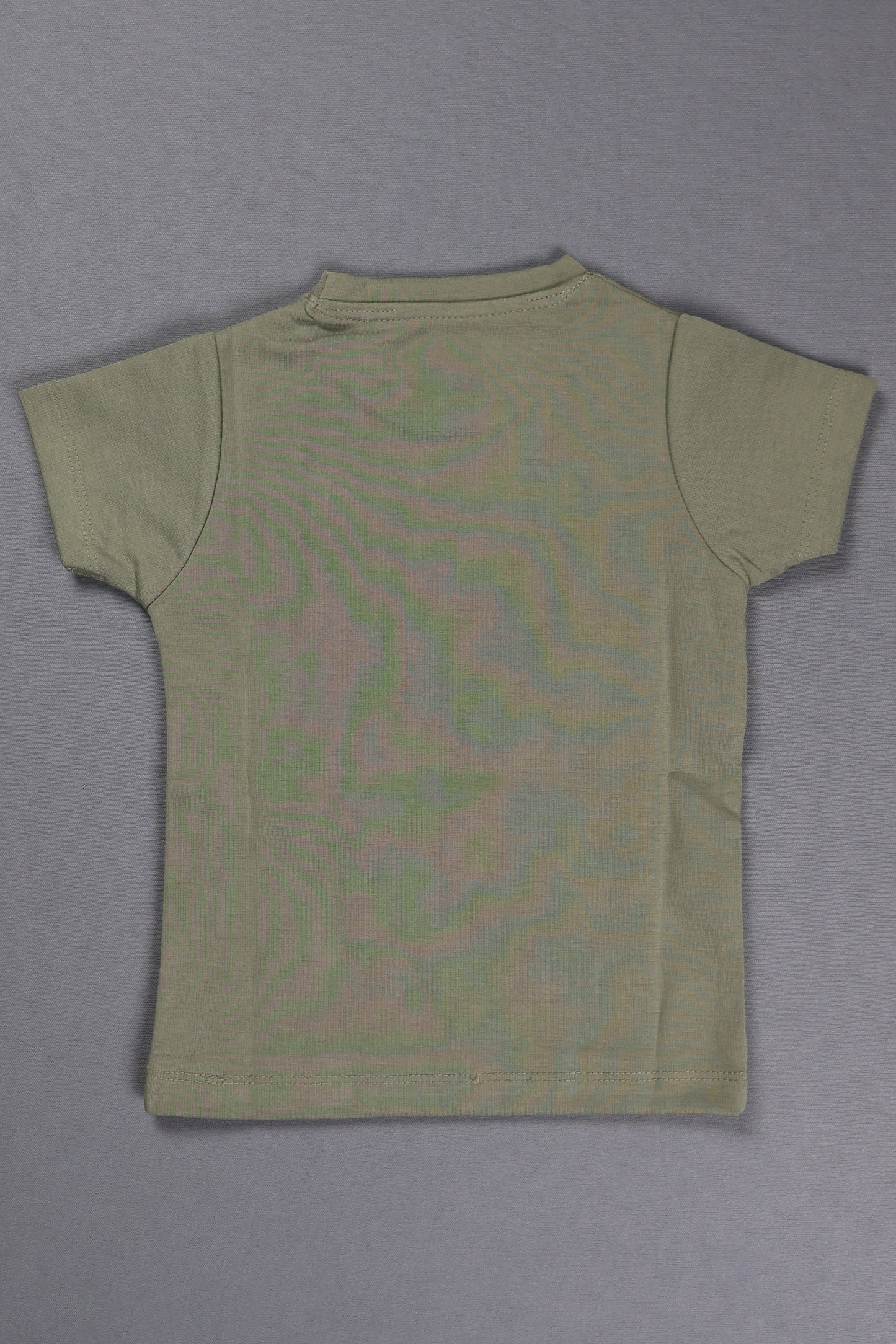 Green t-shirt with a pattern on a gray background
