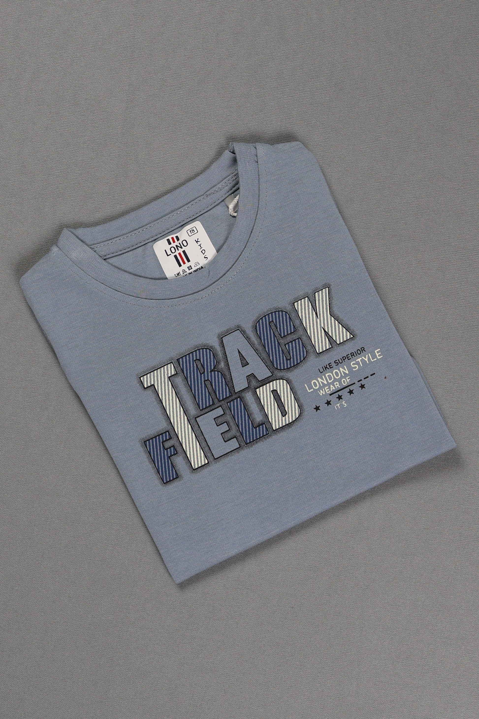 Folded blue t-shirt with 'Track Field' text on a gray background