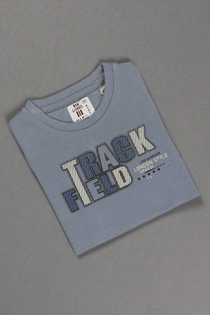 Folded blue t-shirt with 'Track Field' text on a gray background