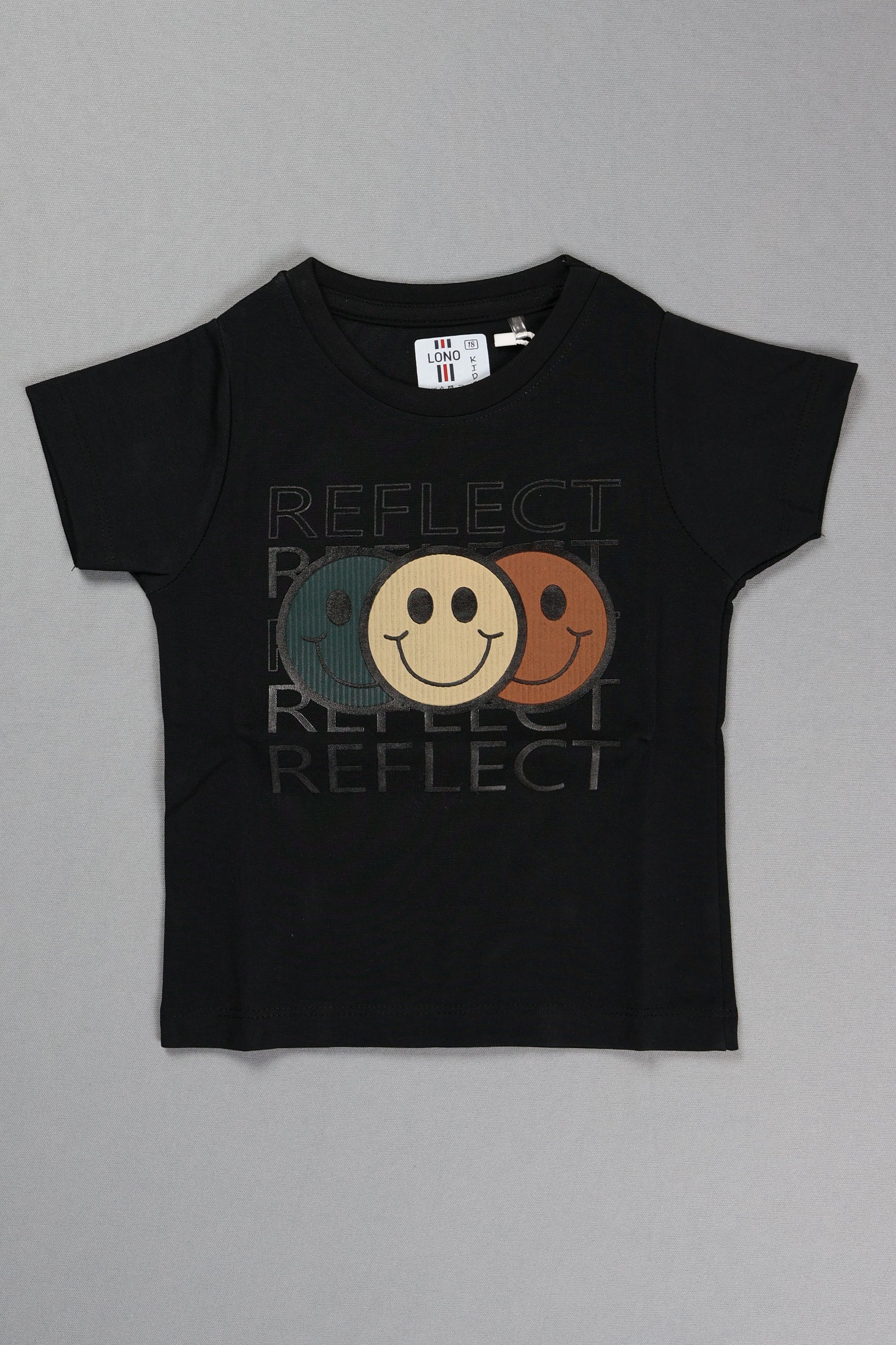 Black t-shirt with smiley face design and 'REFLECT' text on a gray background