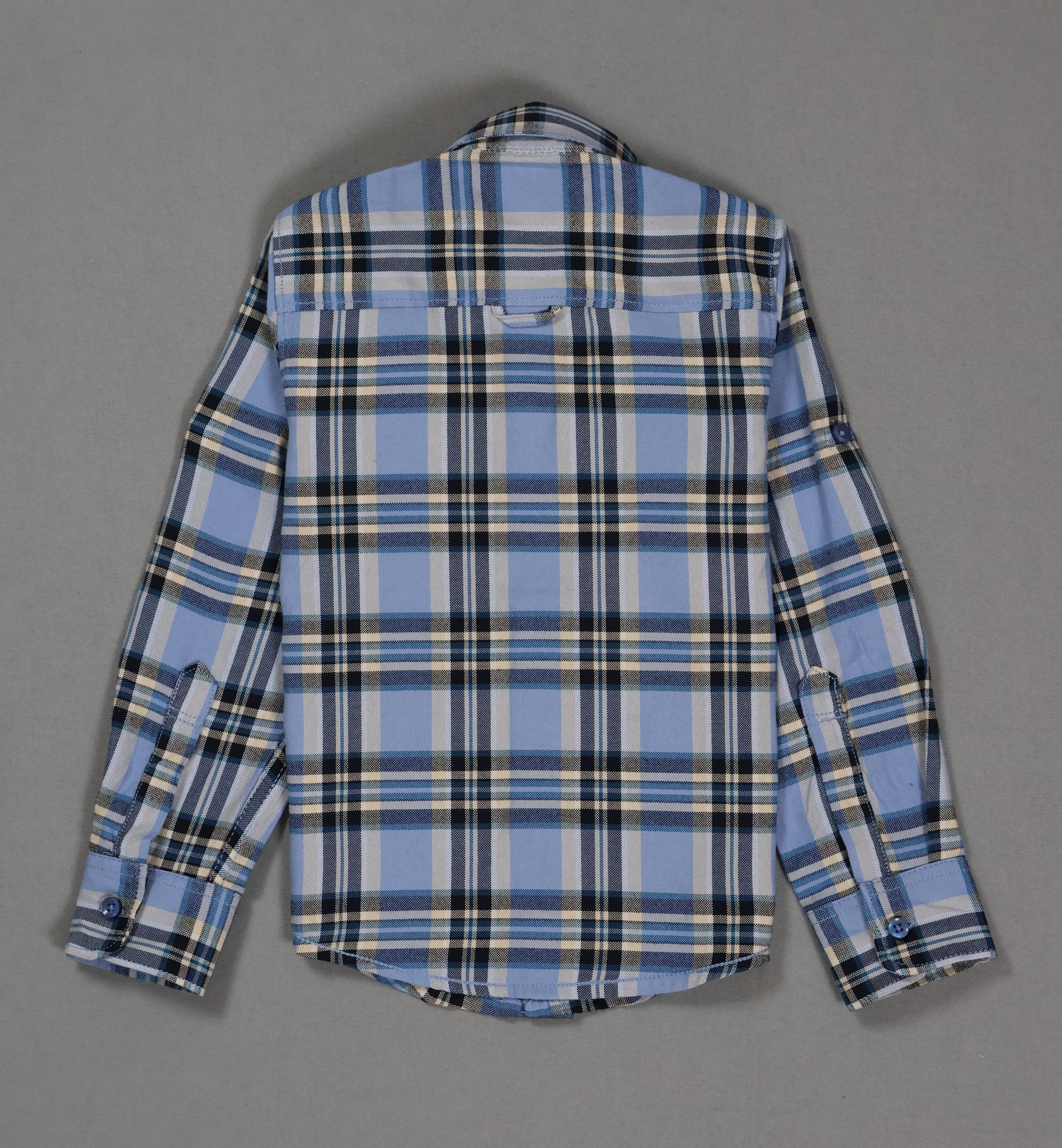 Back view of kids blue plaid cotton shirt with long sleeves on gray background