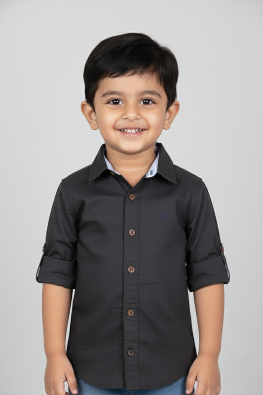 Fyst Boys' Charcoal Grey Solid Long-Sleeve Button-Down Shirt with Roll-Up Sleeve Tabs and Contrast Brown Buttons, worn by smiling child.