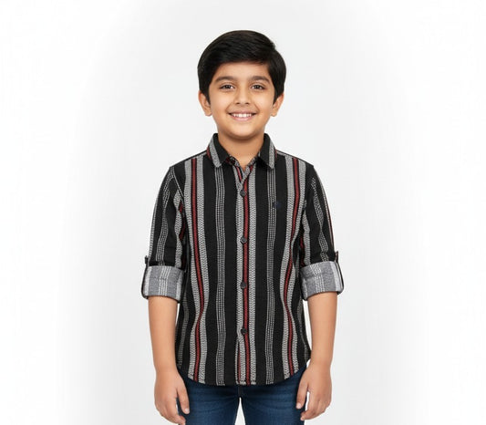 A young boy smiling in a studio portrait, modeling a Fyst brand black button-down shirt with intricate vertical patterns of grey stripes and red lines.