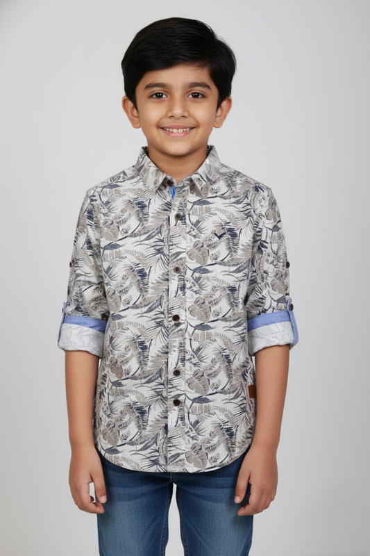Fyst Boys' Grey and Tan Tropical Leaf Print Long-Sleeve Button-Down Shirt with Blue Roll-Up Sleeve Linings, worn by smiling child.