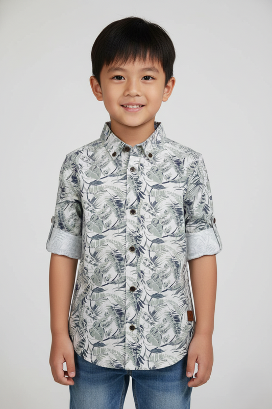 Fyst Boys' Grey and Off-White Tropical Leaf Print Long-Sleeve Button-Down Shirt with Roll-Up Sleeve Tabs, worn by smiling child.