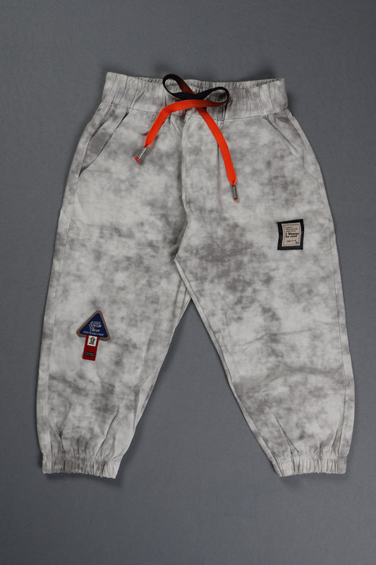 Gray sweatpants with orange drawstring on a gray background