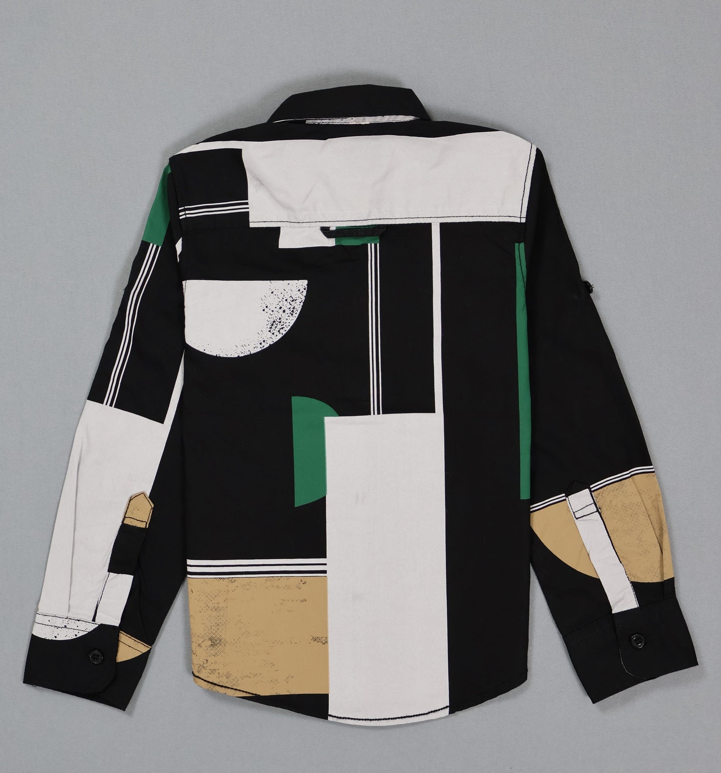 Kids cotton shirt with abstract geometric black, white, green, and beige pattern, back view