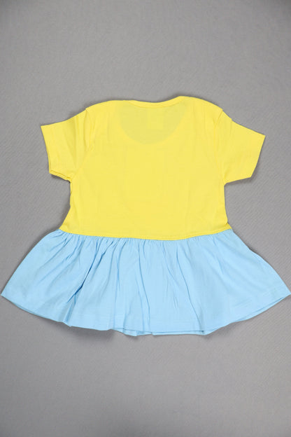 Yellow top and blue skirt on a gray background