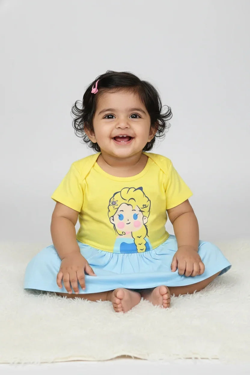 Smiling infant wearing premium cotton color-block princess frock in yellow and blue
