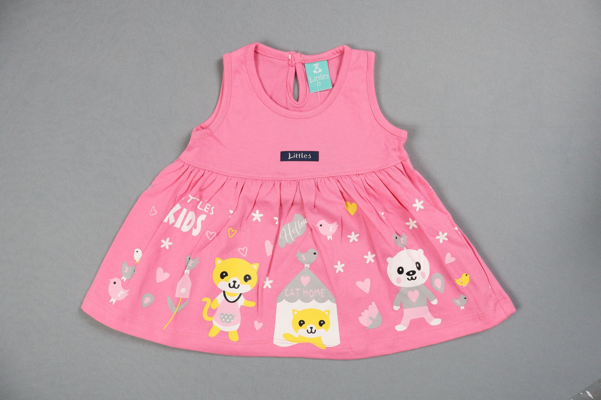 Pink baby romper with cartoon designs on a gray background