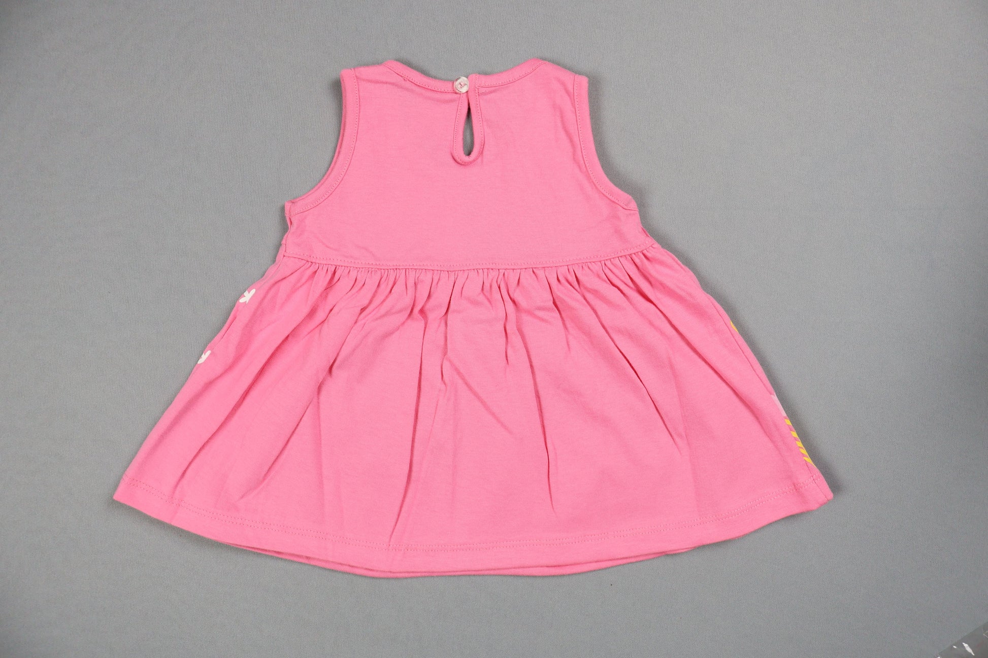 Pink swimsuit top on a gray background