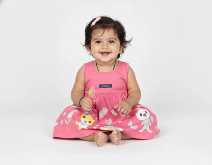 Baby wearing a pink dress with animal prints on a white background