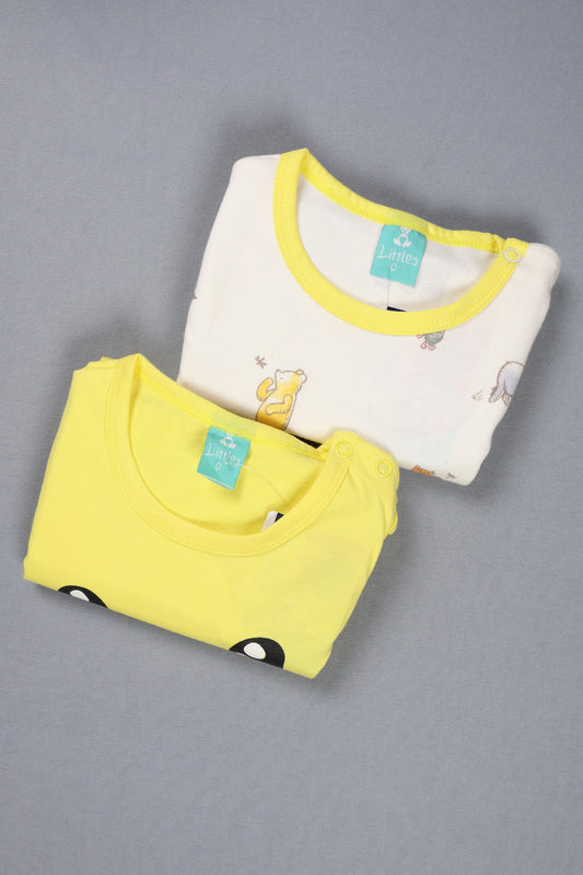 Two folded baby shirts, one yellow and one white with yellow trim, on a gray background.