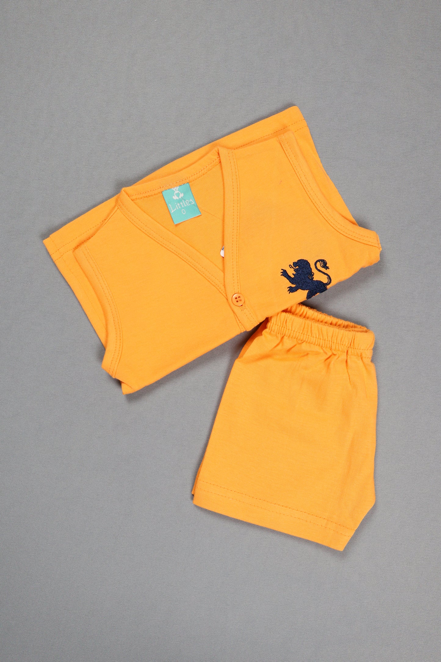 Orange shorts with a black design on a gray background