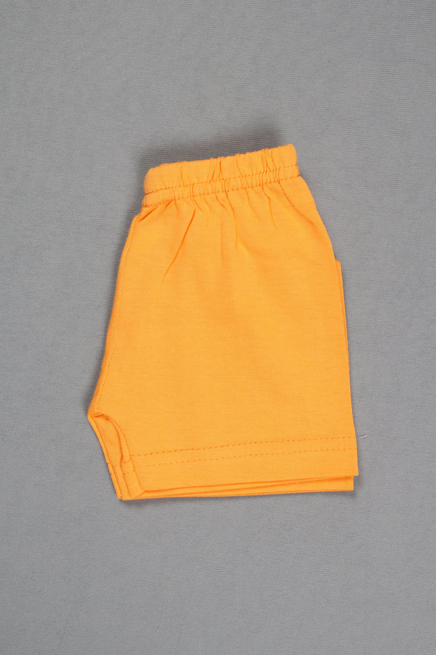 Folded orange fabric on a gray background