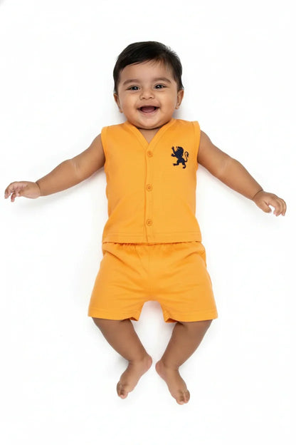 Smiling baby boy wearing orange cotton sleeveless vest and shorts set with lion emblem