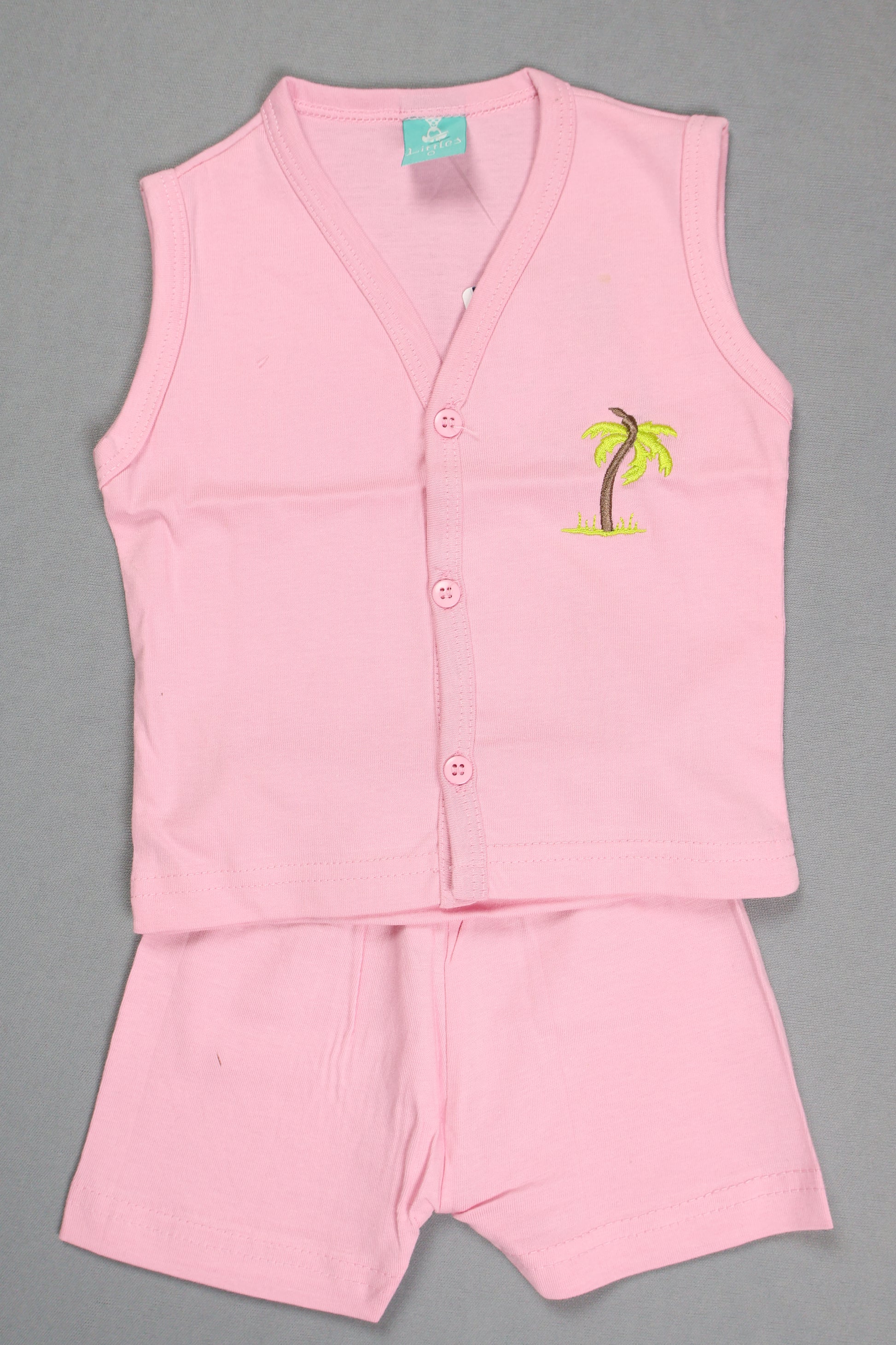 Pink sleeveless shirt with a small logo on a gray background