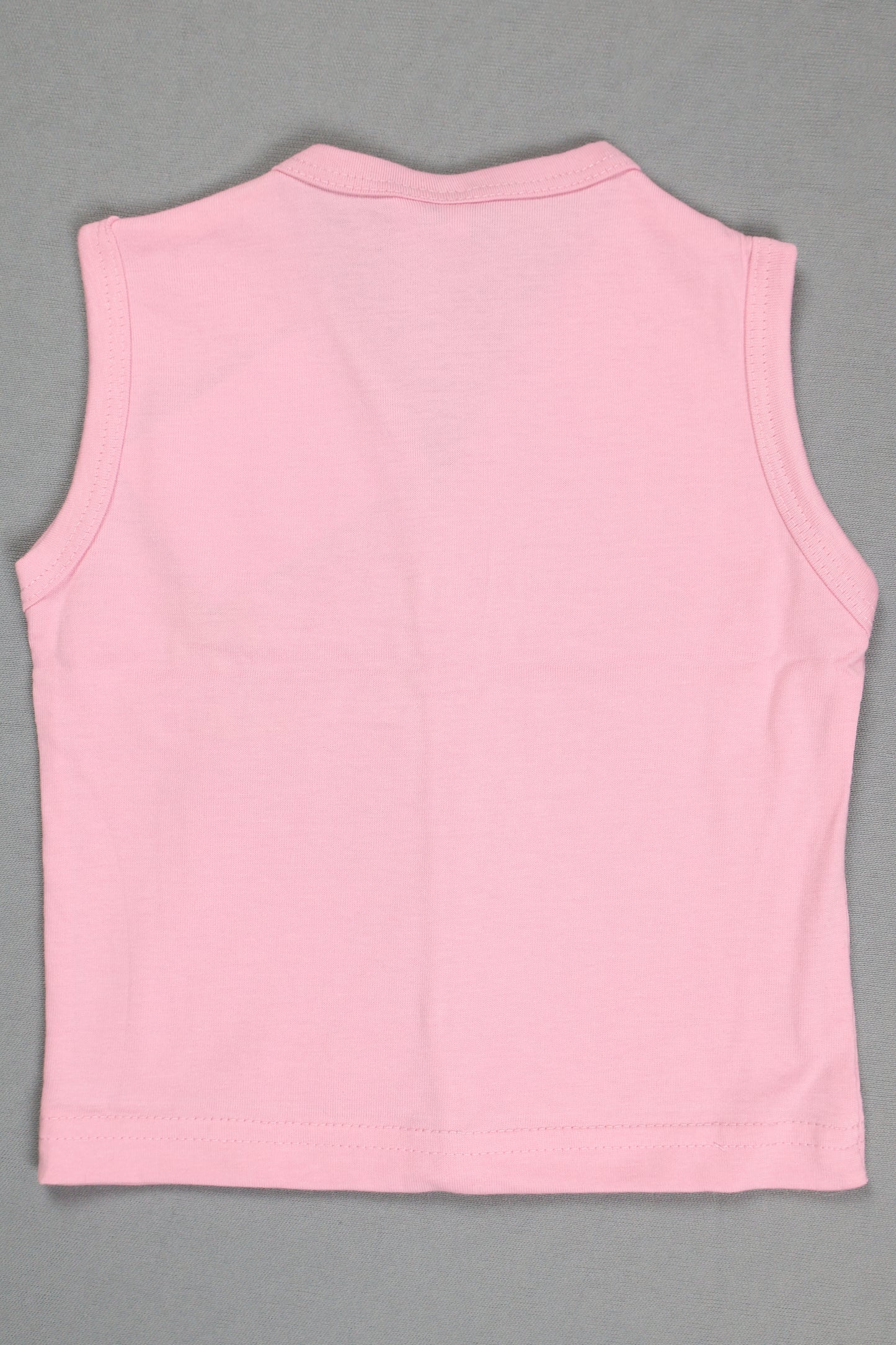 Pink sleeveless top on a gray background