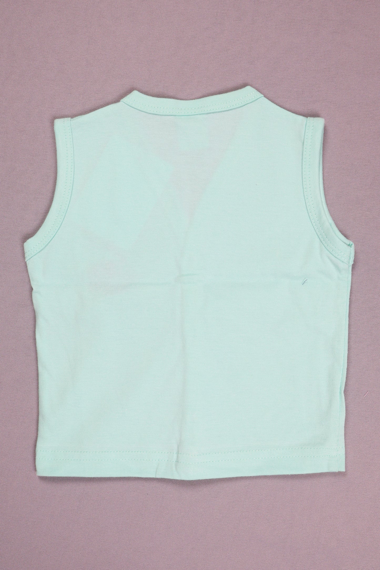 Light blue sleeveless top on a pink background
