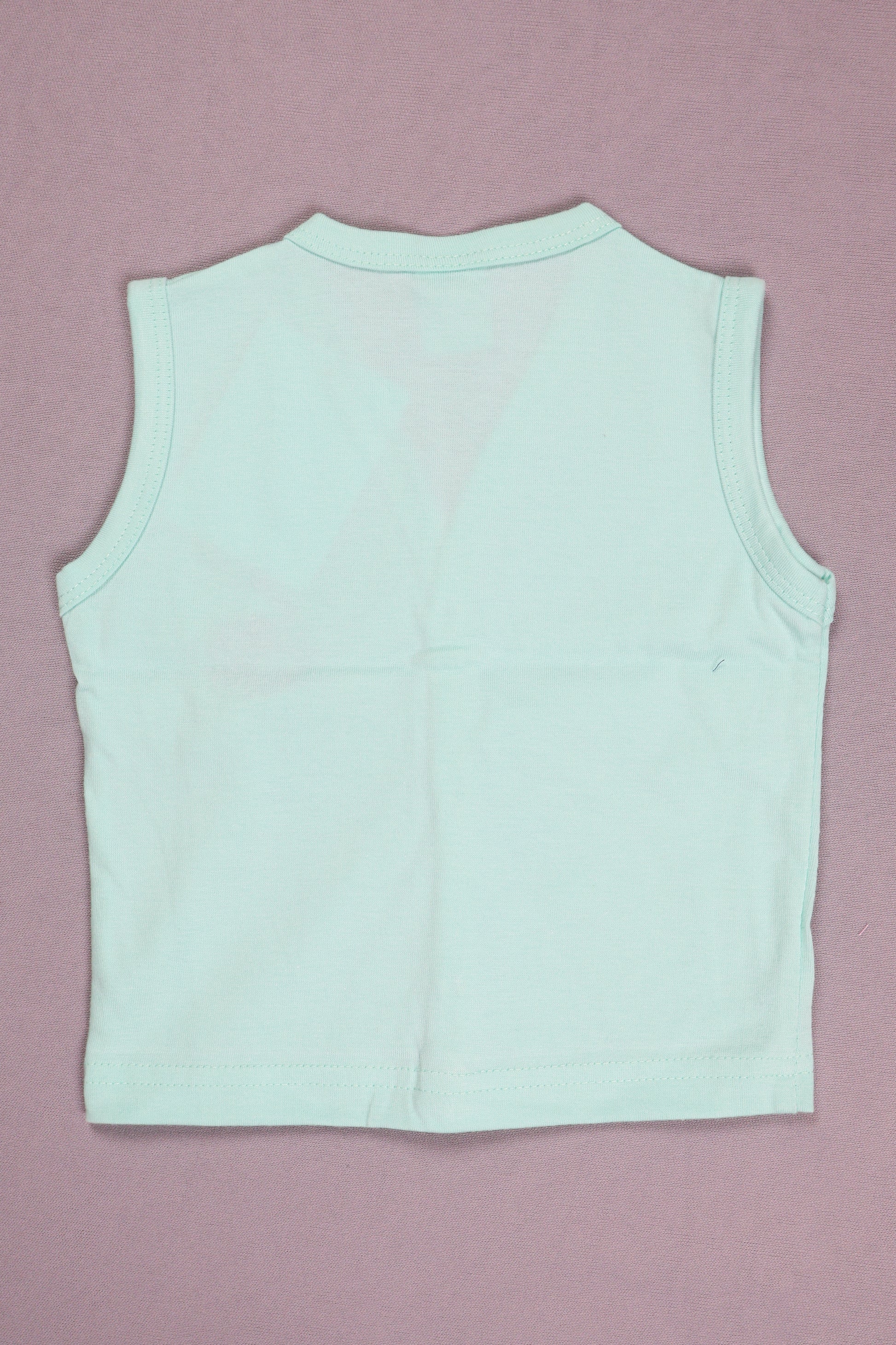 Light blue sleeveless top on a pink background