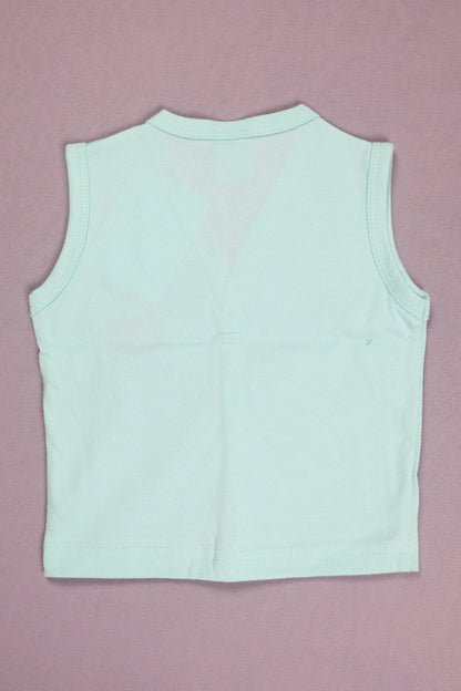 Light blue sleeveless top on a pink background