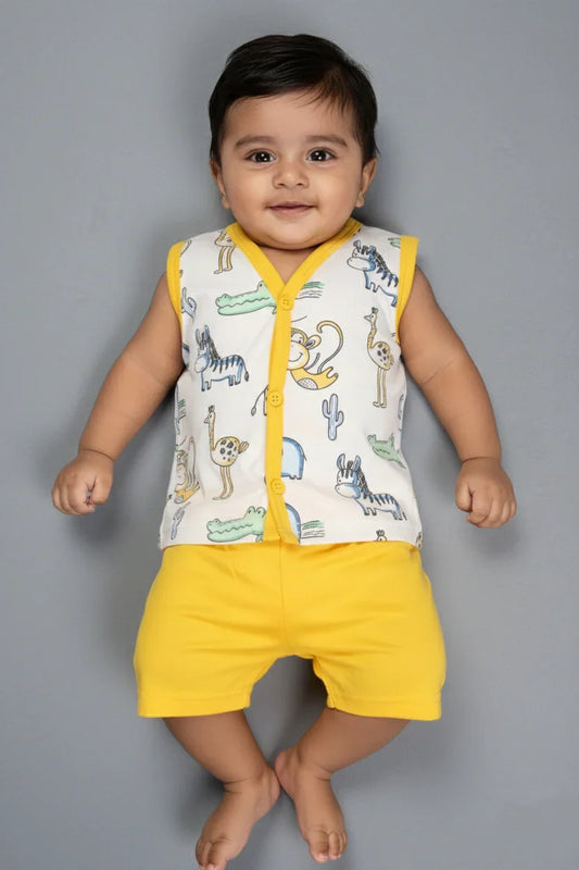 Baby boy in white animal print cotton vest and yellow shorts set, smiling on grey background
