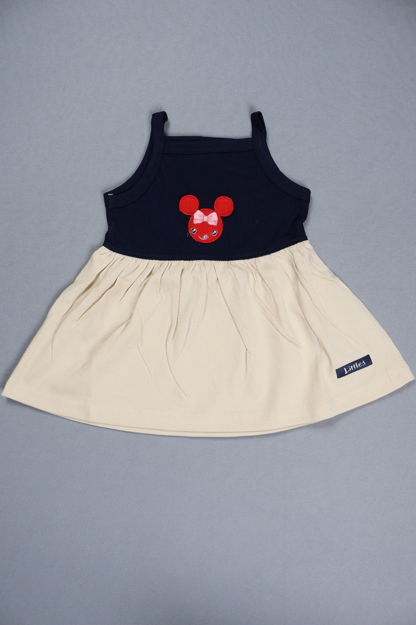 Children's dress with a red bow design on a gray background