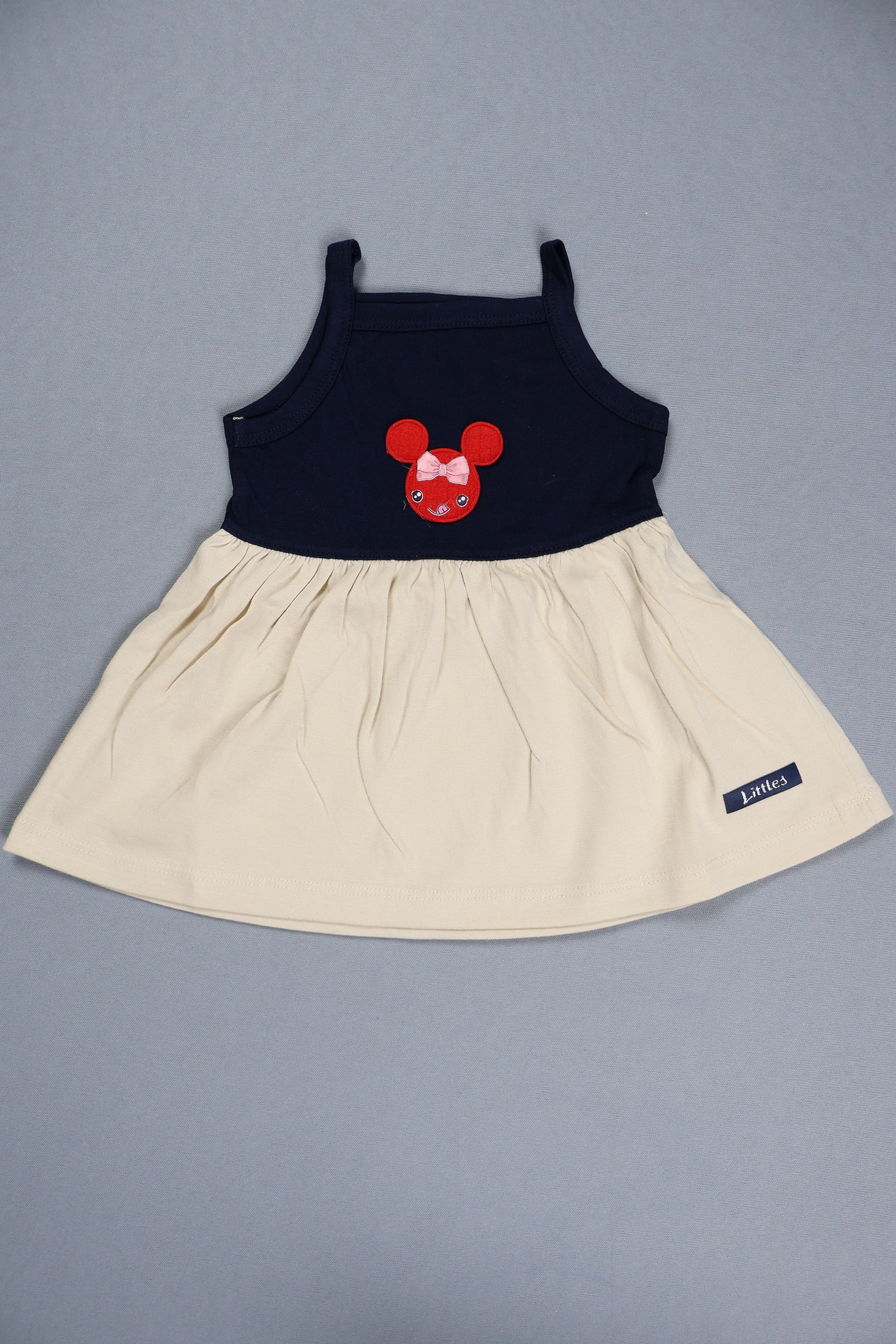 Children's dress with a red bow design on a gray background