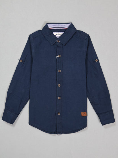 Navy blue button-up shirt on a gray background