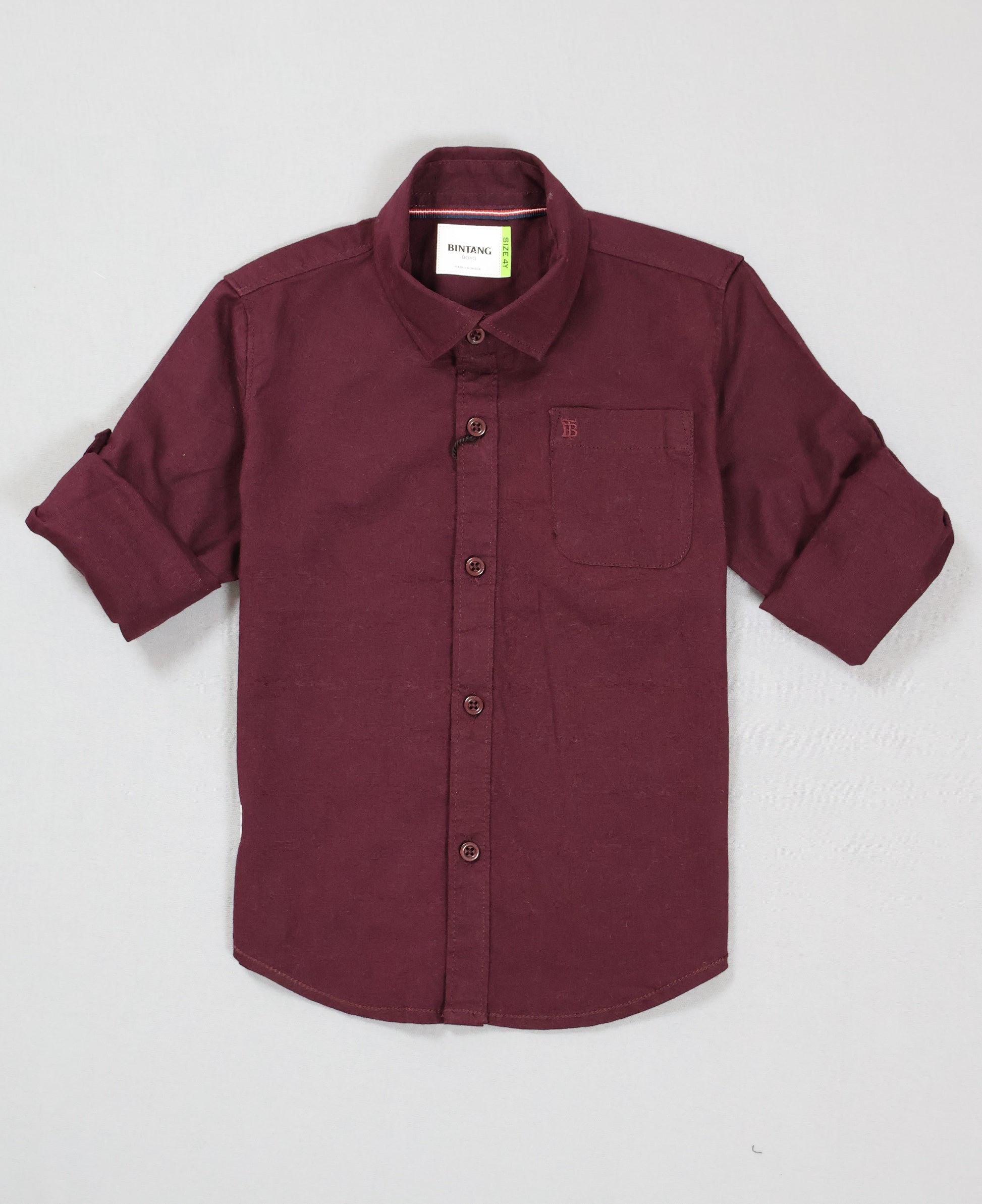 Maroon shirt with rolled-up sleeves on a light gray background