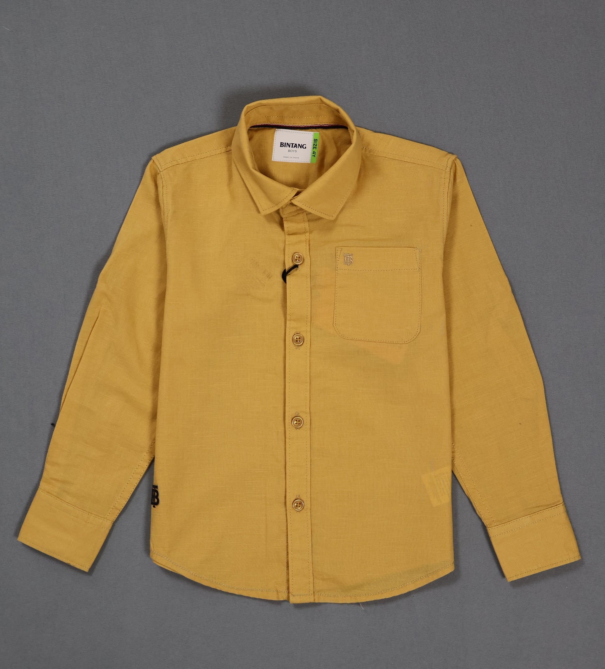 Yellow shirt with a collar and pocket on a gray background