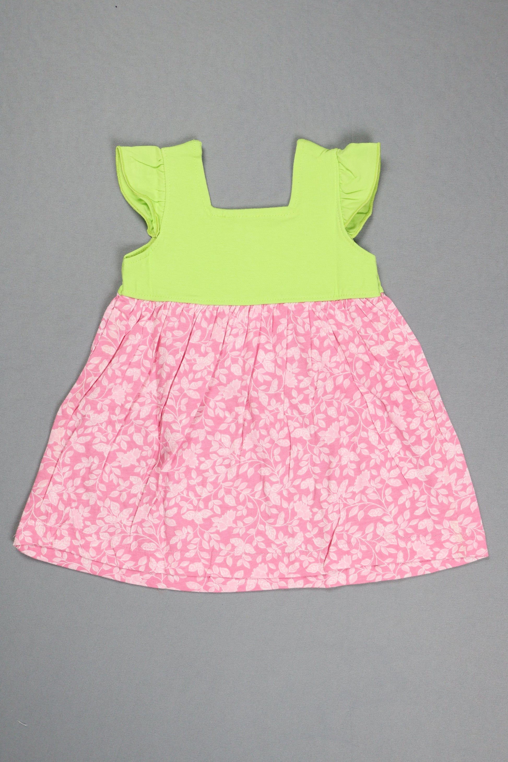 Pink floral fabric and green fabric on a gray background