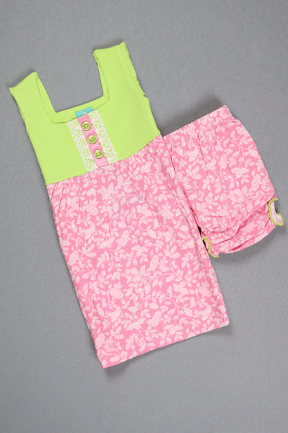 Pink floral fabric with a green patch on a gray background