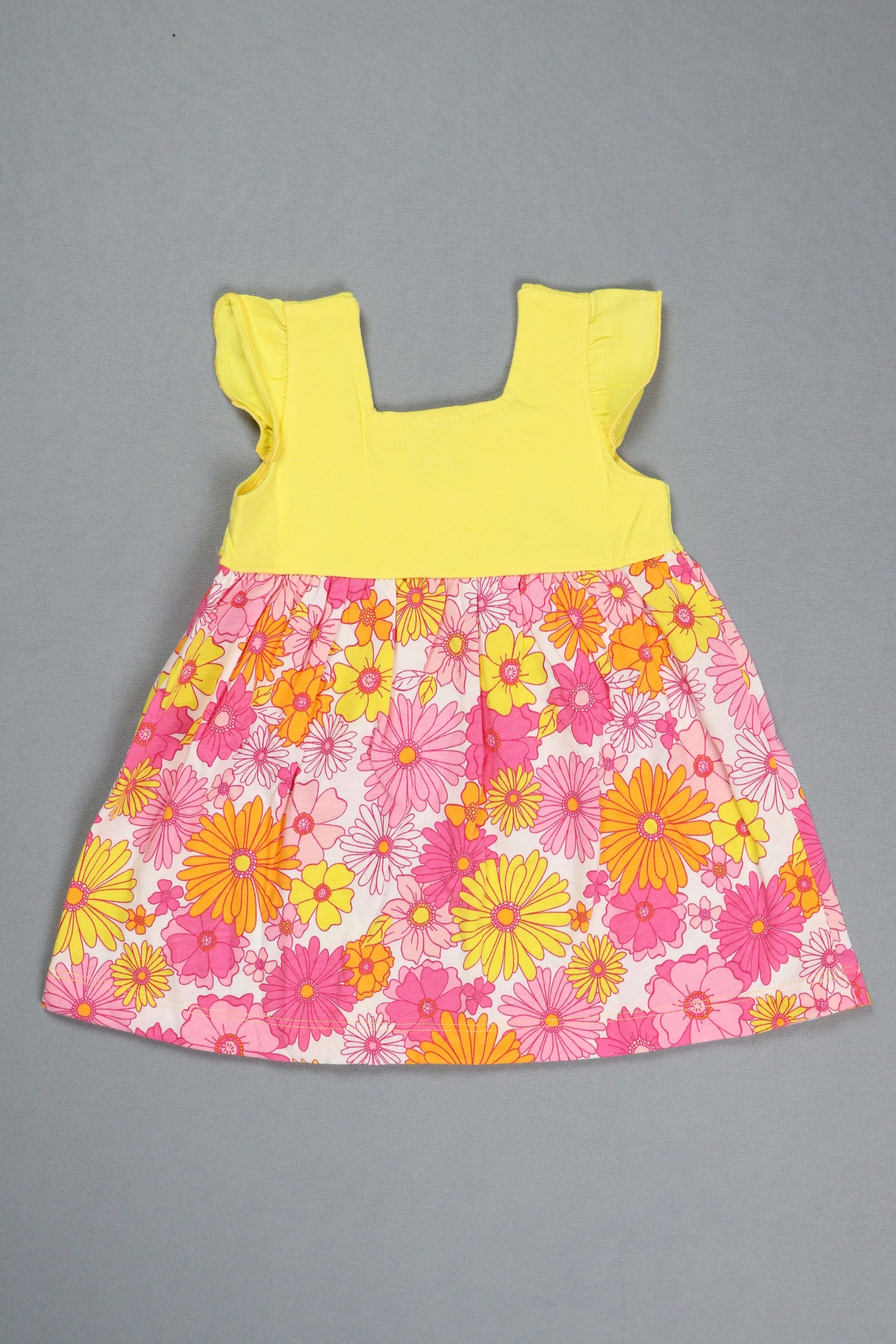 Floral fabric piece with pink and yellow flowers on a gray background