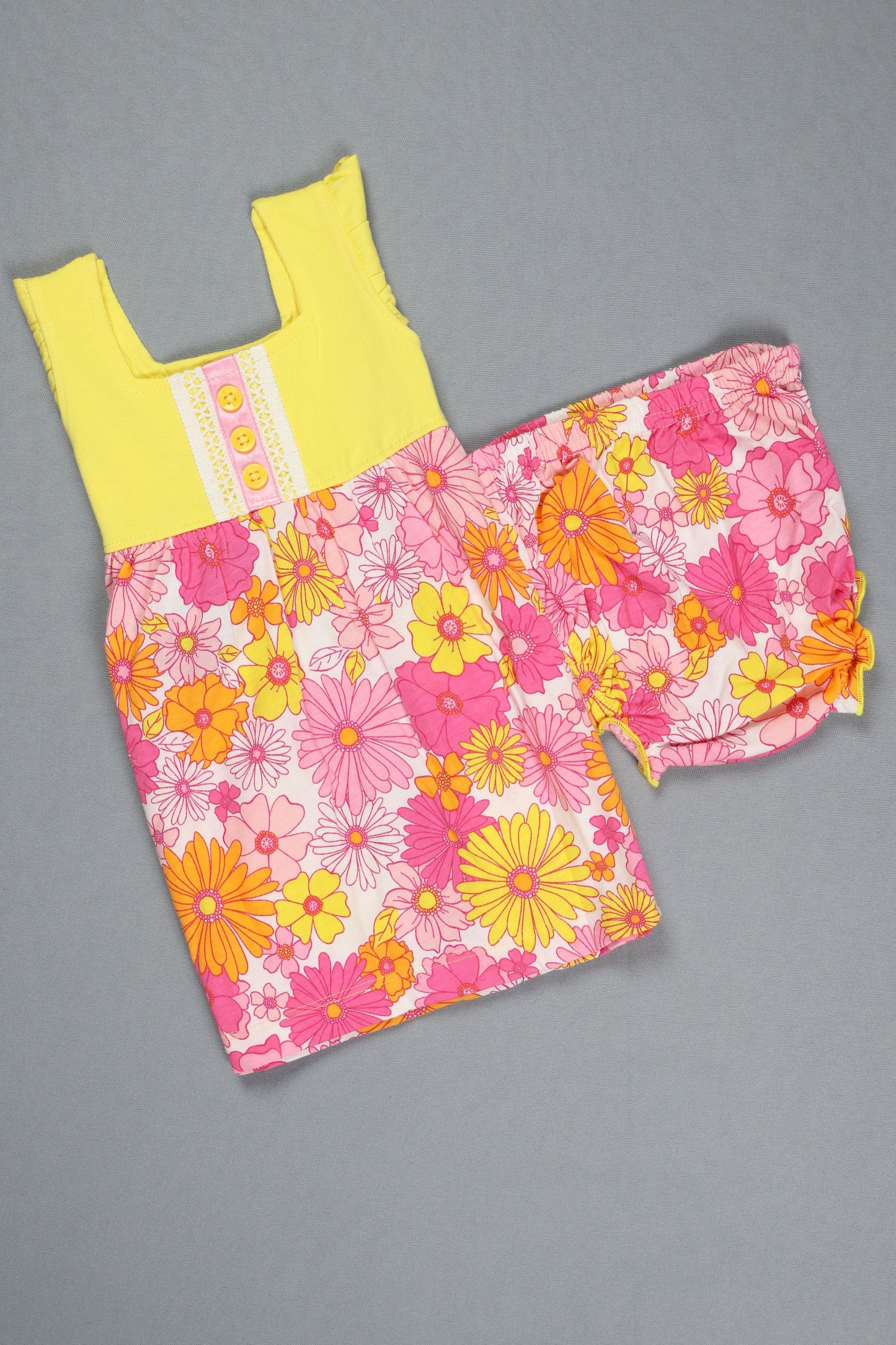 Children's floral dress with yellow sleeves on a gray background
